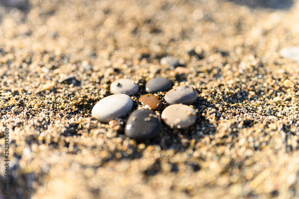 arrangement of colored sea stones and sand arrangement of colored sea stones and sand