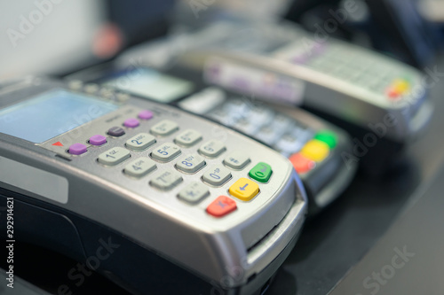 Credit card swipe machine And a young woman holding a credit card to pay for purchases using money from the card. Or installment payments