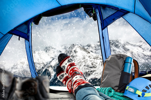 Woman legs with christmas socks and mountains landscape of Alps 