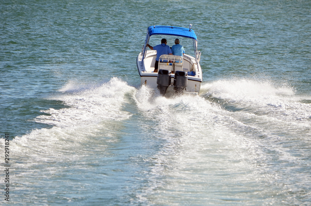 Naklejka premium two old fishing buddies speeding on the florida intra-coastal waterway off Miami Beach.