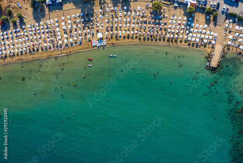 Tropical beach with colorful umbrellas - Top down aerial view. Lindos , Rhodes, Greece