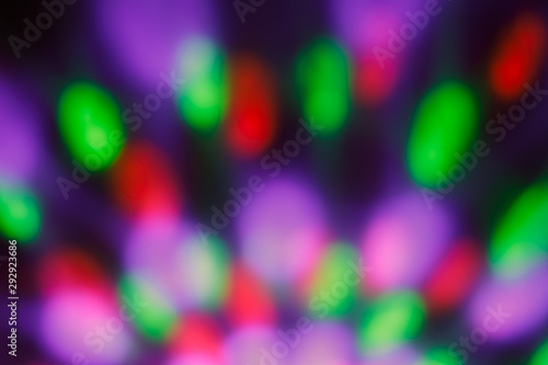 Colorful blurred bokeh with night light. Abstract festive background, pattern. Defocused illuminated dark backdrop. Lights disco backgrounds. 