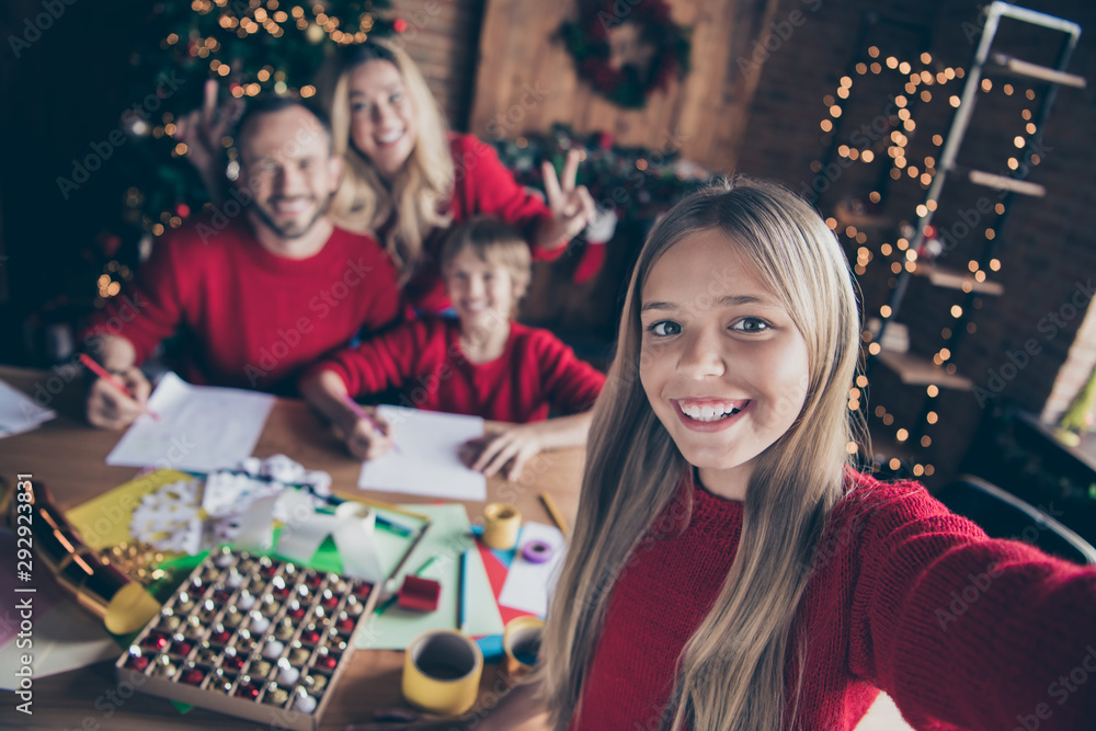 Fototapeta premium Photo of big family parents sister brother spending x-mas eve together writing santa claus wish letter shooting selfies sitting table indoors wear red jumpers