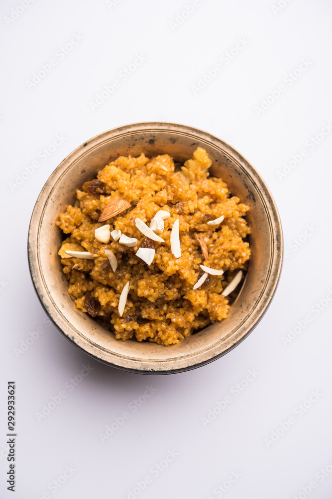 Wheat Laapsi/Lapsi/Shira/Halwa is an Indian sweet dish made of broken wheat or Daliya pieces and ghee along with nuts, raisins and dried fruits. It's a healthy food. served in a bowl, selective focus Wheat Laapsi/Lapsi/Shira/Halwa is an Indian sweet dish made of broken wheat or Daliya pieces and ghee along with nuts, raisins and dried fruits. It's a healthy food. served in a bowl, selective focus