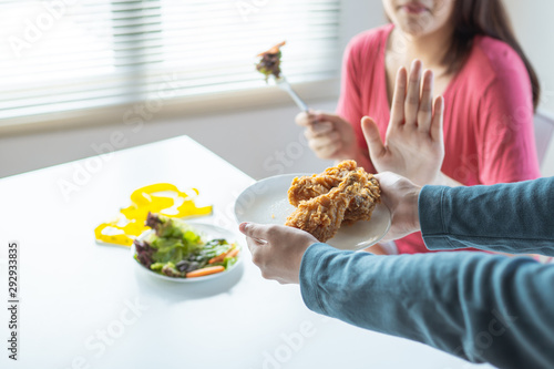 diet woman eateing fresh vegetable and  reject chicken meal