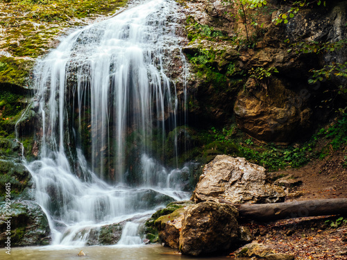 Waterfall mountain river in a wooded area in the fall.