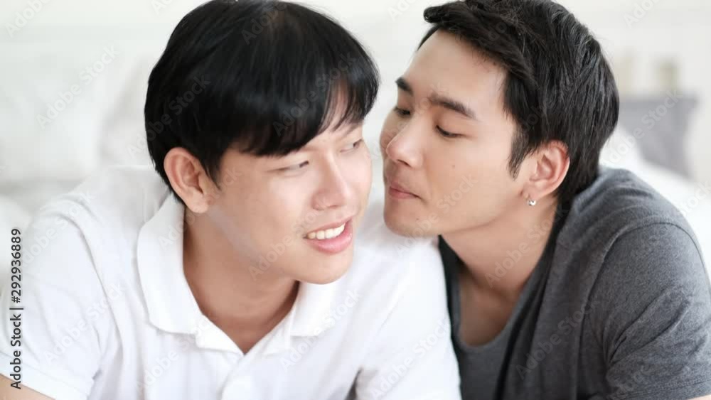 Couple gay stay on bed and show emotion of love by look each other and kiss together with day light. Couple gay stay on bed and show emotion of love by look each other and kiss together with day light.
