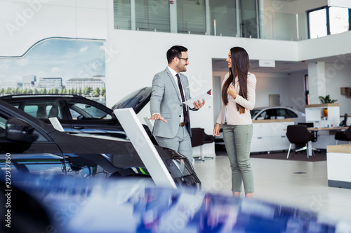 Customer buying a vehicle at car dealership photo