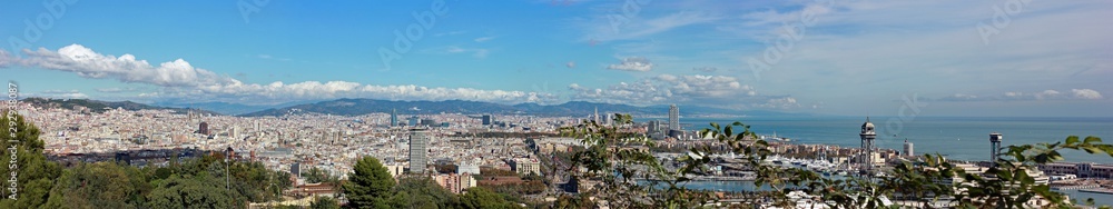 Panoramic view above city Barcelona from Saglada Familia to harbor