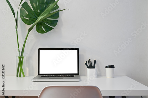 Mockup laptop computer, coffee, pencil and plant decoration with workspace computer.