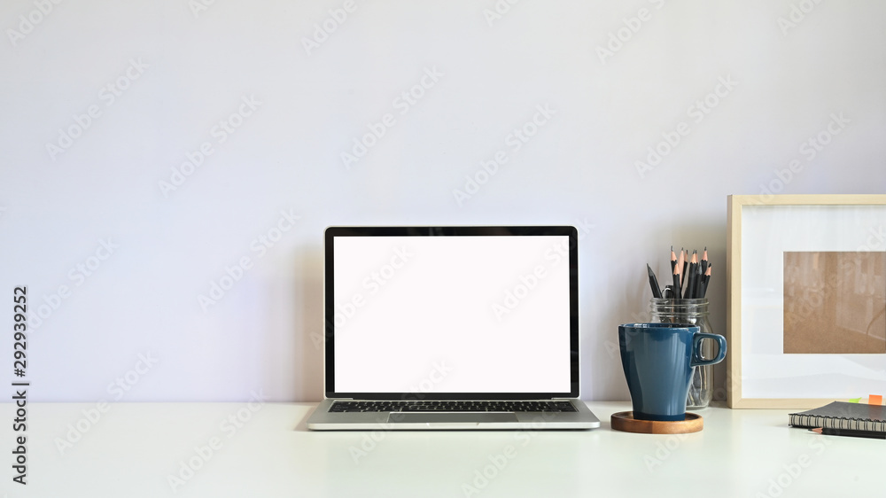 Copy space mockup laptop, coffee mug, pencil with photo frame on workspace desk. Copy space mockup laptop, coffee mug, pencil with photo frame on workspace desk.