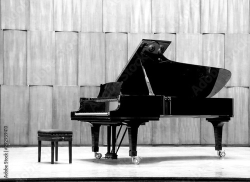 Grand piano set on stage, B&W