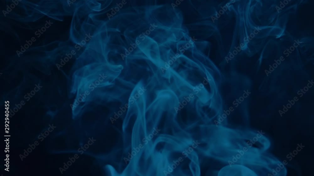 Cinematic blue real smoke slowly floating and rolling through dark space. Abstract foggy and haze texture with mystical effect. Closeup slow motion shot. Shooting with high-speed camera. Cinematic blue real smoke slowly floating and rolling through dark space. Abstract foggy and haze texture with mystical effect. Closeup slow motion shot. Shooting with high-speed camera.