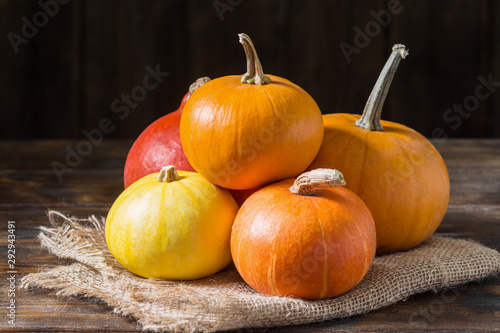 Pumpkins on a wooden table. The concept of the fall harvest