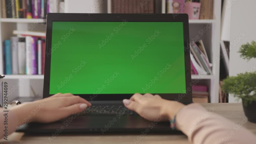 Close-up Woman Works on a Laptop Computer. Female hands Keyboarding Laptop Using Texting Pointing Networking. Green Screen. Chromakey. Shoulder Camera Shot. Living Room. Shot on Cinema Camera Arri Close-up Woman Works on a Laptop Computer. Female hands Keyboarding Laptop Using Texting Pointing Networking. Green Screen. Chromakey. Shoulder Camera Shot. Living Room. Shot on Cinema Camera Arri