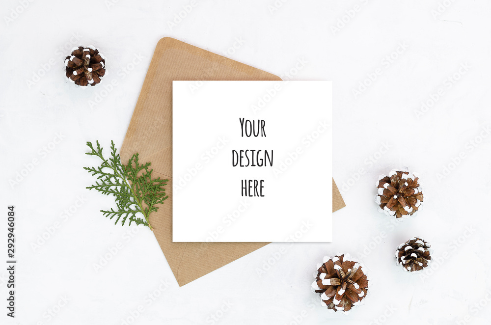 Flat lay Christmas greeting card craft paper envelope decoration minimal composition pinecones on white festive table isolated. New year winter holiday xmas mockup with copy space on a greeting card Flat lay Christmas greeting card craft paper envelope decoration minimal composition pinecones on white festive table isolated. New year winter holiday xmas mockup with copy space on a greeting card