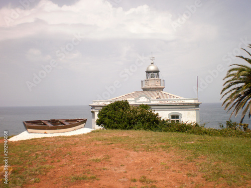 Wonderful Lighthouse With A Boat At Its Doors In Candas. July 8, 2010. Asturias, Spain, Europe. Travel Tourism Street Photography
