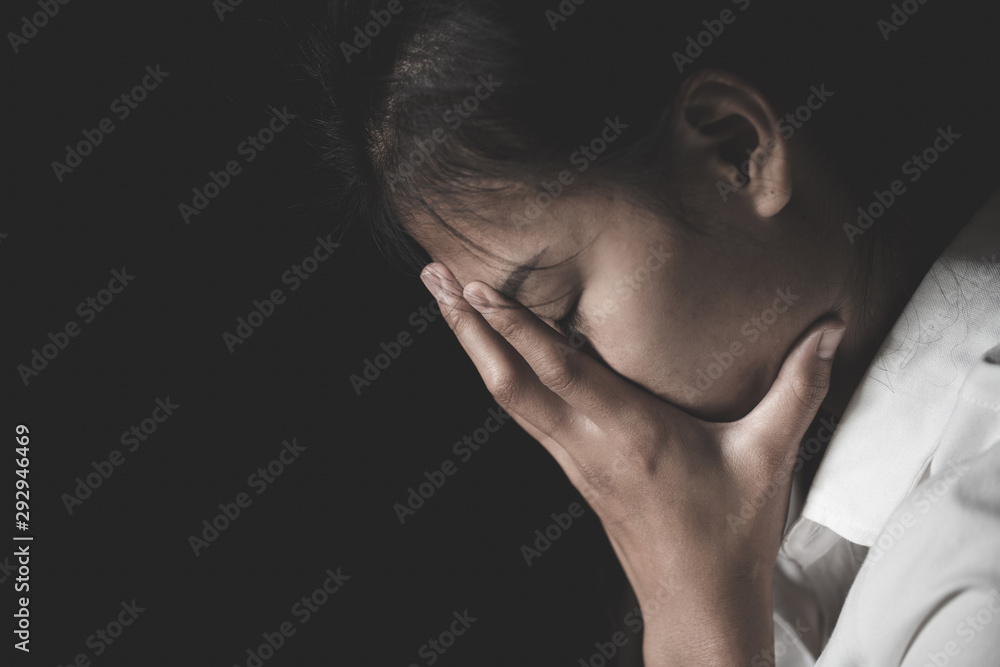 Young depressed woman, domestic and rape violence,beaten and raped sitting in the corner,  Copy space.  International Women's Day