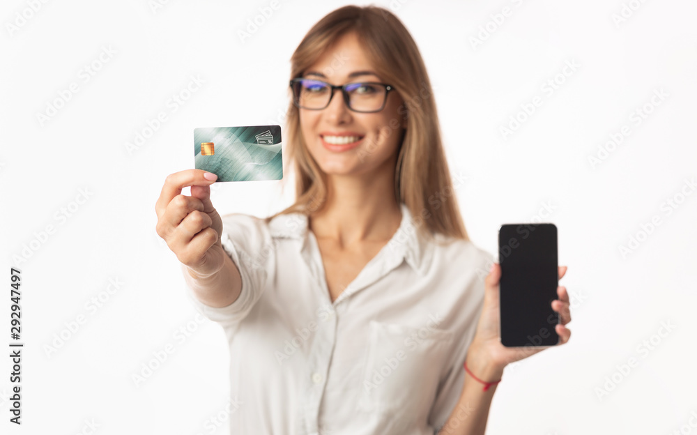 Smiling Business Lady Showing Smartphone And Credit Card, White Background Smiling Business Lady Showing Smartphone And Credit Card, White Background