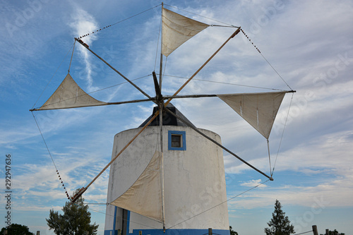Windmill sails in action for milling wheat with sky background