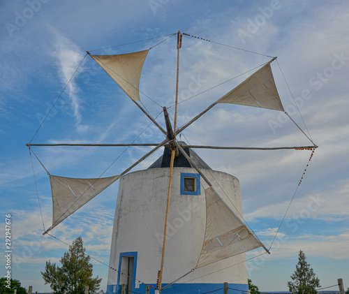 windmill sails in action for milling wheat with sky background