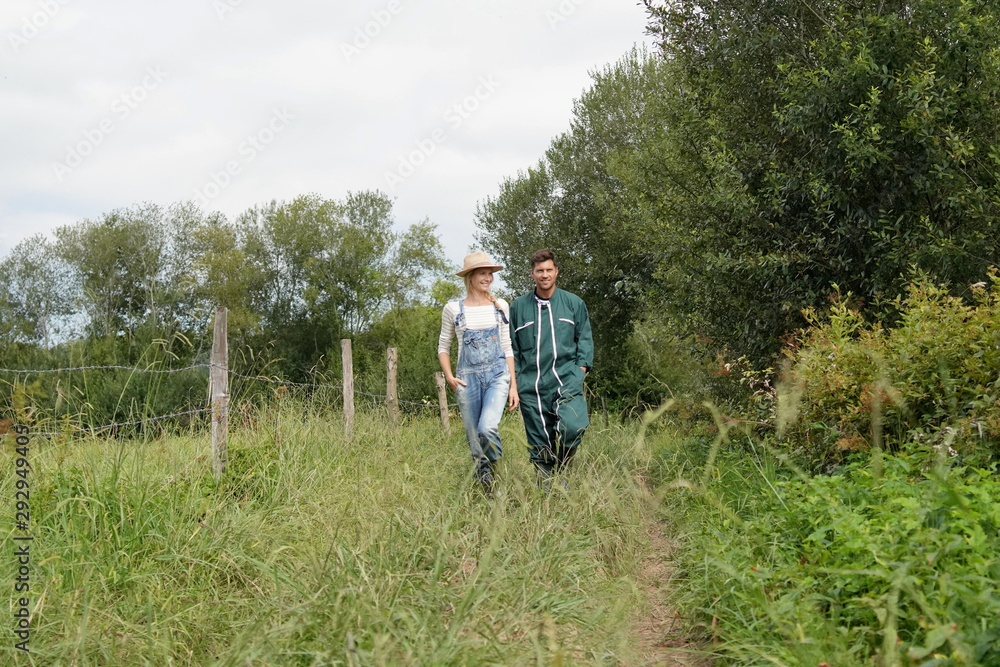 Couple of farmers walking in field