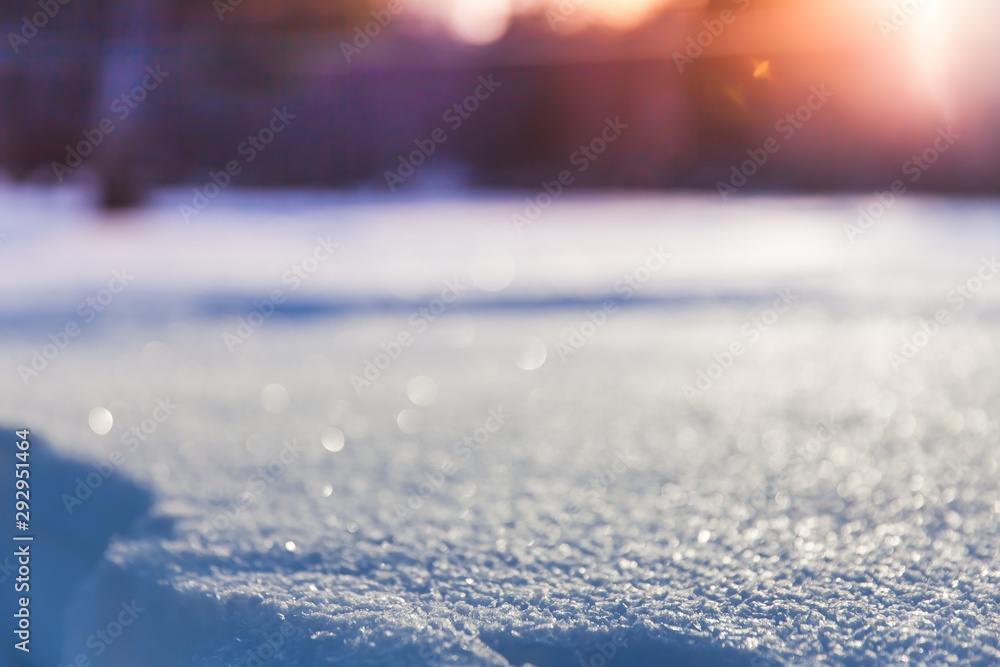 Background of a snowy landscape against a blurred bokeh lights. Fresh snow texture in blue tone. Copyspace for text. Background of a snowy landscape against a blurred bokeh lights. Fresh snow texture in blue tone. Copyspace for text.
