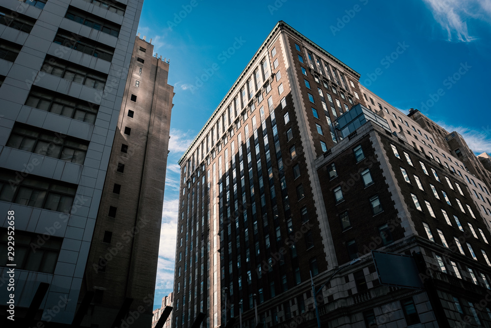 Naklejka premium skyscrapers in the city manhattan new york hotel real estate urban exploration discover walking sign rooms apartment rental leasing architecture building