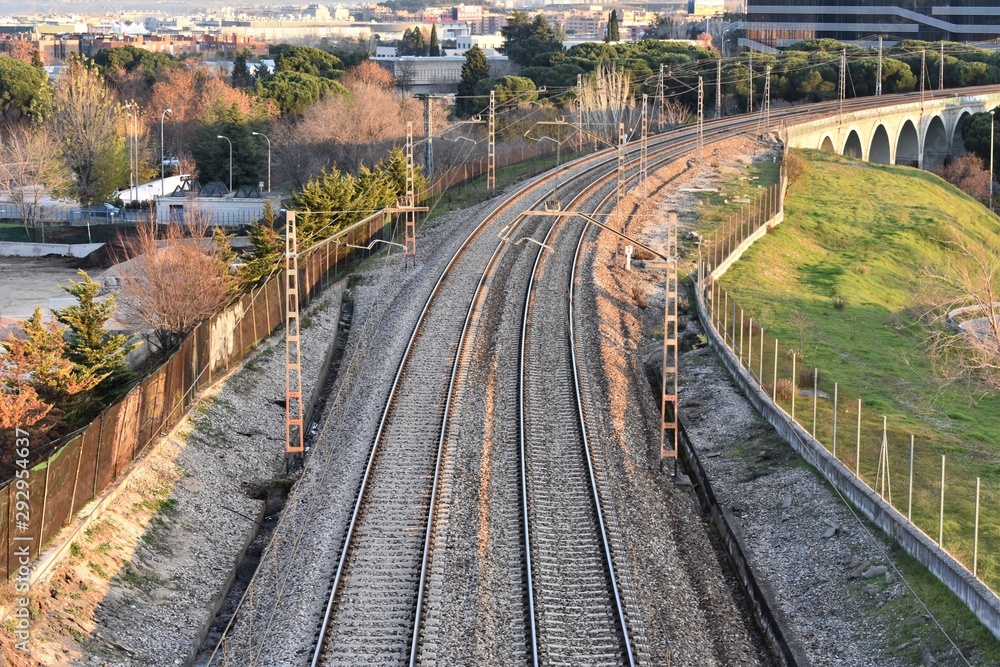 Aerial view of the train tracks entering a city before its arrival at the station