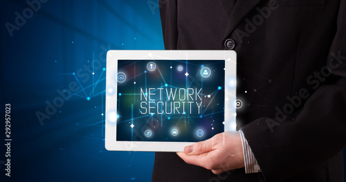 Wallpaper Mural Young business person working on tablet and shows the digital sign: NETWORK SECURITY Torontodigital.ca