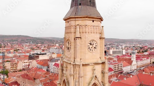 Aerial footage Close to Large Church Tower Clock  in Europe Drone view of Cluj, in the heart of Transylvania, Romania. church medieval tower  photo