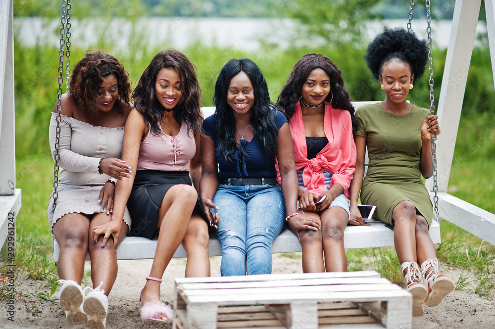 Group of five african american girls relaxing at beautiful swing. Group of five african american girls relaxing at beautiful swing.