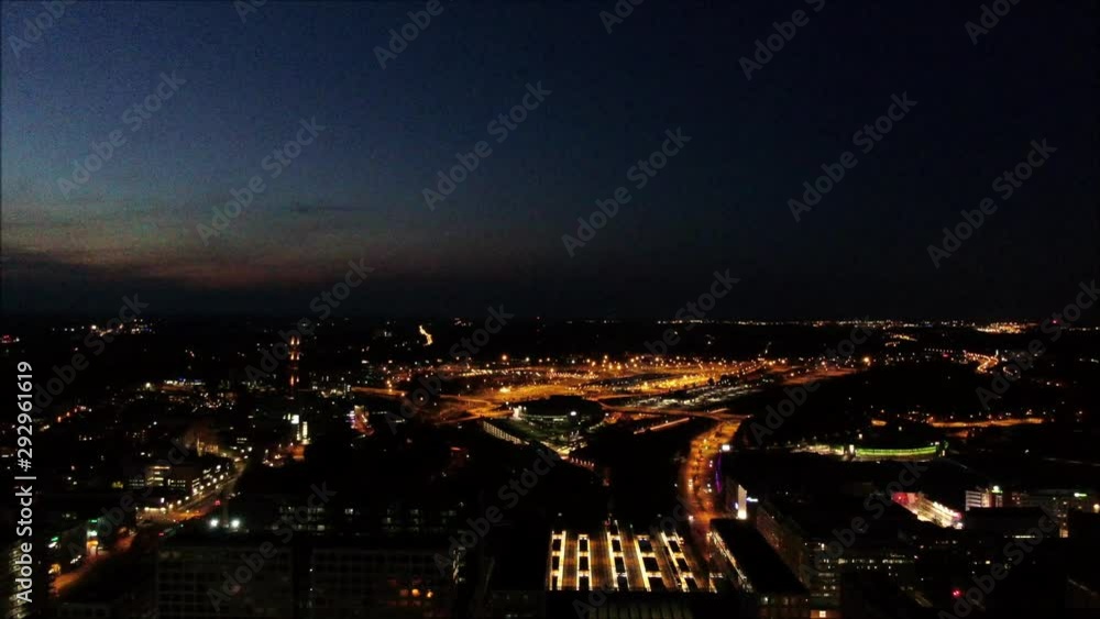 Aerial shot, drone flying backwards over city towards large buildings at night. Illuminated by street lights and building. Helsinki City Aerial shot, drone flying backwards over city towards large buildings at night. Illuminated by street lights and building. Helsinki City