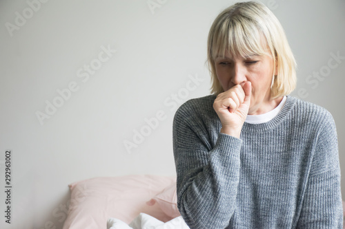 Senior woman is sick, sore throat,cough isolated on white background.Sick woman with sore throat and having cough. 