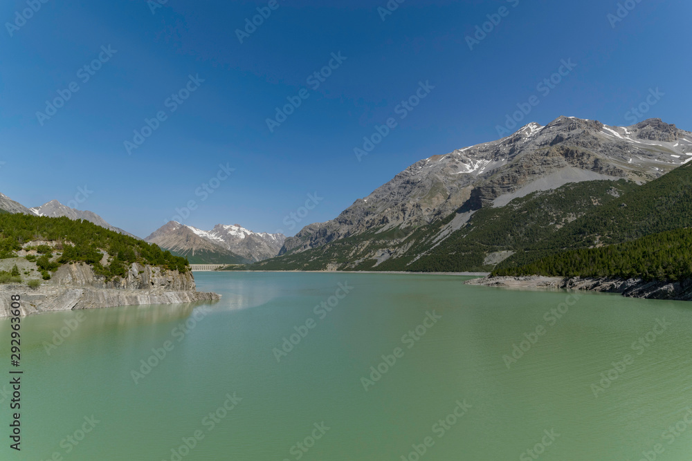 Lake Cancano in the italian alps, surrounded by huge mountains