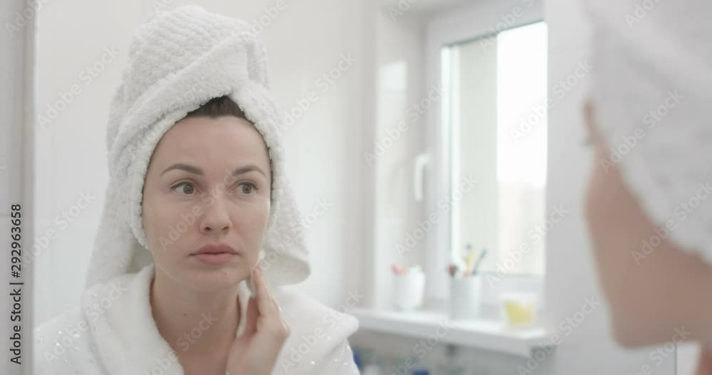 Woman Cleaning Skin with a Cotton Pad Removing Makeup Shot on Red Epic Woman Cleaning Skin with a Cotton Pad Removing Makeup Shot on Red Epic