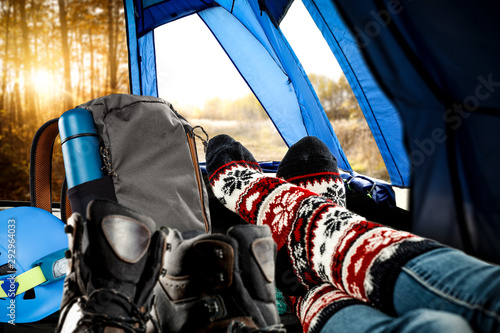 Woman legs with socks and autumn tent interior 