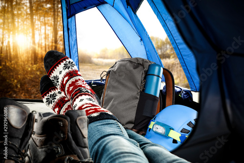 Woman legs with socks and autumn tent interior 