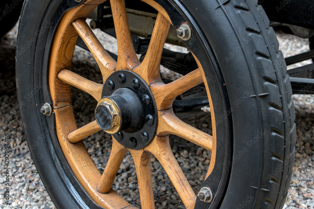 Wheel of retro car with wooden rim, close up.