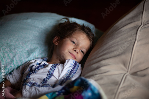 A little girl resting on her pillow