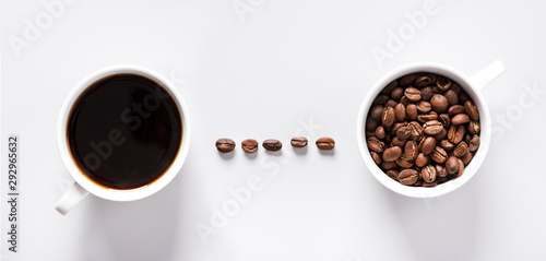 Espresso coffee and roasted coffee beans in white cups on a grey background, top view, copy space, flat lay.