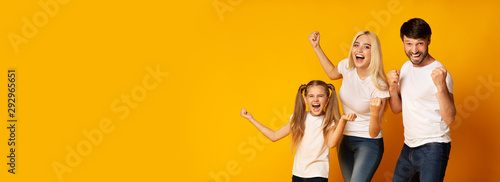Family Of Three Shaking Fists Gesturing Yes, Yellow Background, Panorama
