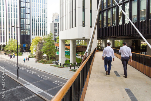 In the city of London office workers walk along a new section of the elevated walkway or so called pedway that was constructed in 2017 along and above London Wall road and Tower Of St Elsyng Spital photo