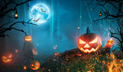 Spooky halloween pumpkins in dark forest