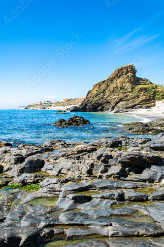 a great tranquil beach scene in Spain with crystal blue waters in the background portrait 