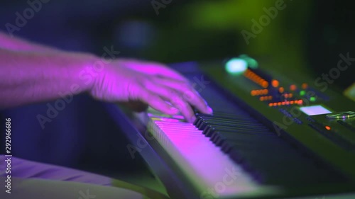 Musician playing keyboards on the concert close up photo