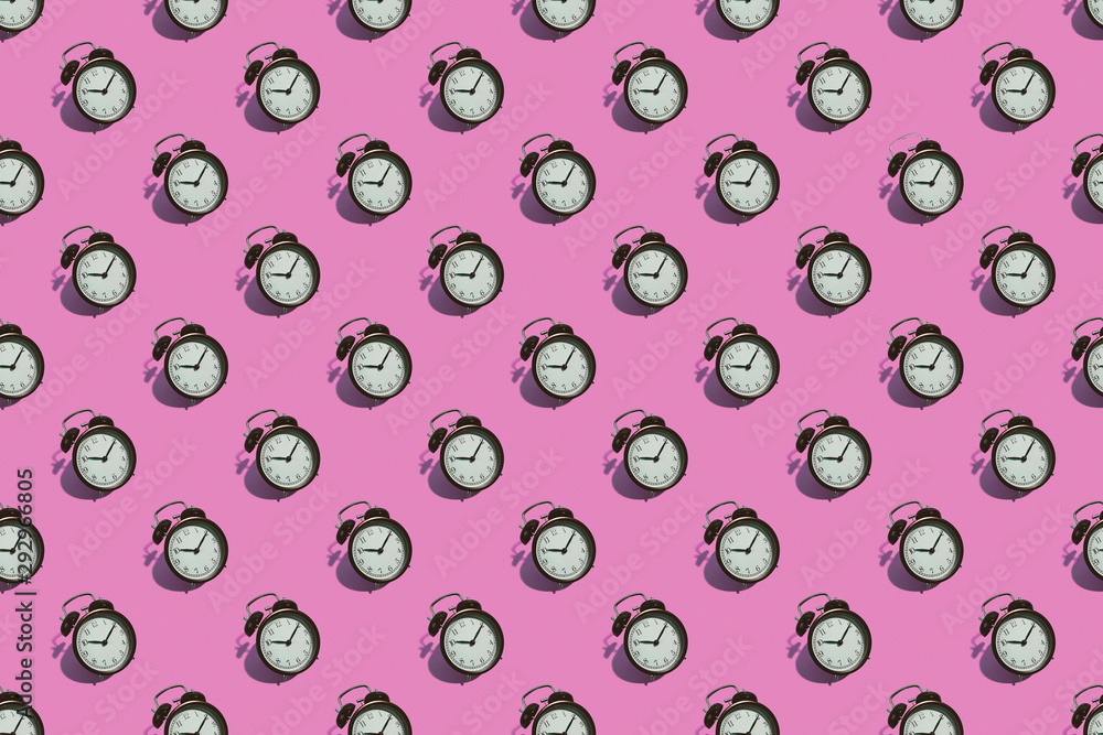 Many black classic style alarm clock with hard shadow isolated on pink background. Smile time concept. Pattern Many black classic style alarm clock with hard shadow isolated on pink background. Smile time concept. Pattern