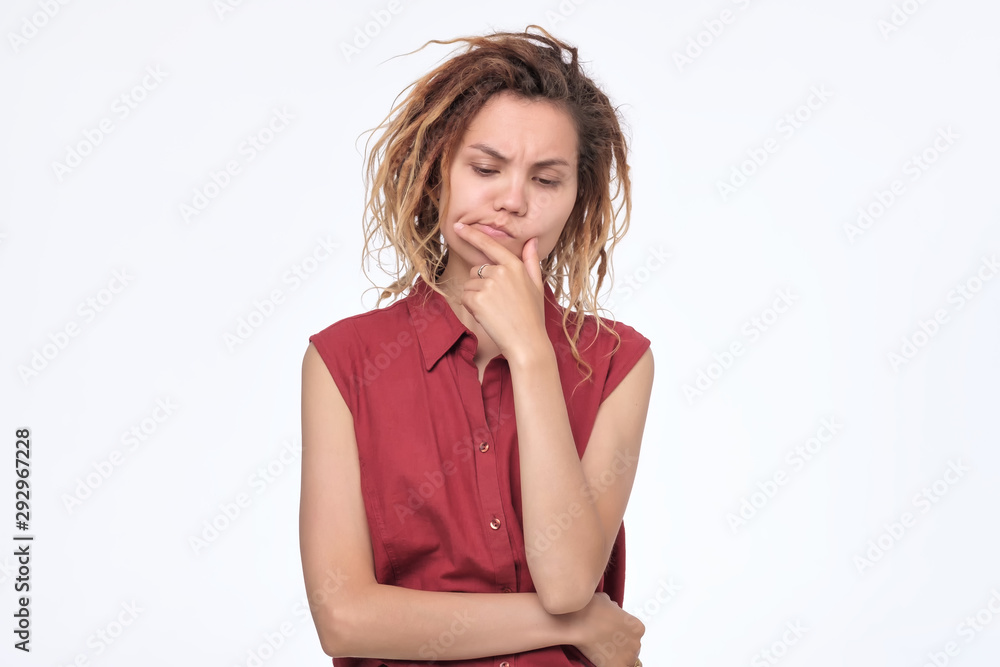 woman with dreadlocks frowning her face having doubt and suspicion feeling woman with dreadlocks frowning her face having doubt and suspicion feeling