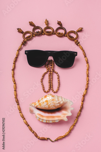 funny face made of sunglasses, necklaces and shells