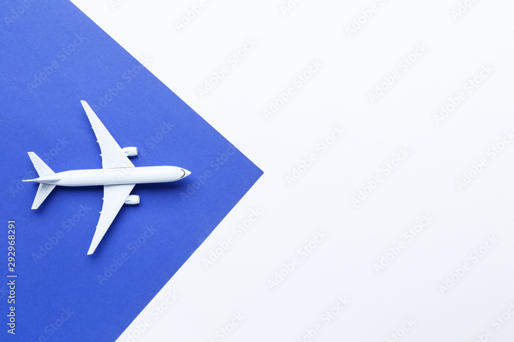 Airplane model on blue paper background Airplane model on blue paper background